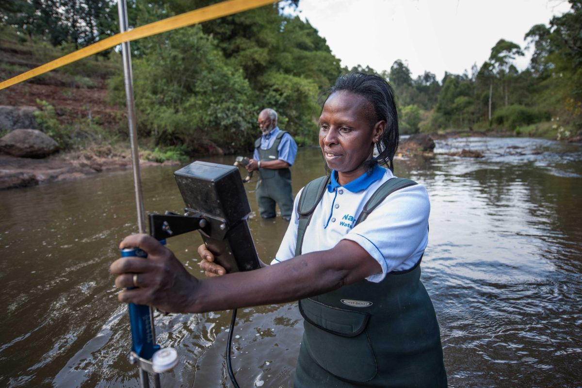 Faith Mbathi with Wangombe Thuku at the gauge monitoring station at Gura River. The WARMA team, who have partnered with the NWF, come at least once a month with their equipment to measure water quality (sediment levels), water quantity (volumn) and use a Acoustic Doppler Current Profiler (ADCP)- the boat looking tool-to measure the depth, width and flow of the water. WARMA employs 2 locals to measure the water levels twice a day using the water stick. WARMA team: Faith Mbathi (wearing waders), Jane Njoroge (big hair), Wangombe Thuku (bearded man), Michael Muthoro (computer guy).