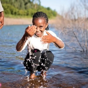 A visit to the Ndakaini dam. The twins Joy and Joan are so excited to play in the water but they can't swim so they won't venture too far out. The twins sing and dance on the way back to the farm teasing Susan.

***

Family: James Kariuki
Area: Gatanga Region, Thika
Farm type: Tea plantation on the foothills of Ndakaini Dam. The dam supplies 88% of water to Nairobi city. The water source is the Aberdare mountains.

Family members at home:
1. Esther Wanjiru Kariuki, Mama- 60 years old, gave birth to 11 children all at home without outside help!
2. James Kariuki, Father, 66 years old
3. Joel Ruku Kariuki, Son, 19 years old
4. Susan Gathoni Kariuki, Daughter, 17 years old
5. Simon Mwangi Kariuki, Youngest son, 15 years old
- 11 children in total
- 9 grandchildren in total
- Twins Joy Wairimu Wangari and Joan Wanjiru Wangari (11 years old) are visiting their grandparents for their Christmas holidays. They spend 2 months here.

NWF Sustainable Farming practices:
- have a water pan with tilapia fish which they will sell at 200/300 kshs
- use water pan during the dry season (they are prohibited to use the dam water on their farms)
- terracing for vegetables taught by NWF representative Carol
- have planted more Avocado trees as a cash crop as instructed by NWF representative Carol
- only buy flour, sugar, sometimes bread and oil. The rest they grow on their farms. 
-Have chickens, rabbits, a goat and a cow for milk daily 
- use fire wood from the farm as fuel for cooking 

Food crops:
Arrow root 
Black night shade (spinach)
Kale (sukumawiki)
Cabbage 

Cash crops:
- avocado 
- tea 
- kale, cabbage, spinach
- Tea- 1KG sold at 10 shillings plus 40-50 kgs bonus per kg paid at year end. Approx 400kg of tea per month.

Daily schedule:
- 6:00 am mama and baba wake up to pray in their room (you can hear them from my room)
- 6:30 am start boiling water and milk the cow. TV switched on to gospel music.
- 7:00 am Chai (milk with a tint of tea) and breakfast (left over dinner from the