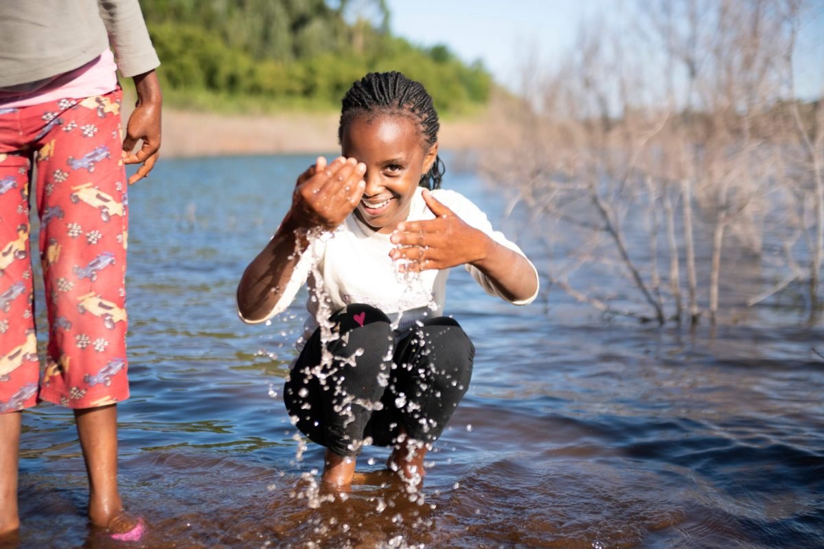 A visit to the Ndakaini dam. The twins Joy and Joan are so excited to play in the water but they can't swim so they won't venture too far out. The twins sing and dance on the way back to the farm teasing Susan.

***

Family: James Kariuki
Area: Gatanga Region, Thika
Farm type: Tea plantation on the foothills of Ndakaini Dam. The dam supplies 88% of water to Nairobi city. The water source is the Aberdare mountains.

Family members at home:
1. Esther Wanjiru Kariuki, Mama- 60 years old, gave birth to 11 children all at home without outside help!
2. James Kariuki, Father, 66 years old
3. Joel Ruku Kariuki, Son, 19 years old
4. Susan Gathoni Kariuki, Daughter, 17 years old
5. Simon Mwangi Kariuki, Youngest son, 15 years old
- 11 children in total
- 9 grandchildren in total
- Twins Joy Wairimu Wangari and Joan Wanjiru Wangari (11 years old) are visiting their grandparents for their Christmas holidays. They spend 2 months here.

NWF Sustainable Farming practices:
- have a water pan with tilapia fish which they will sell at 200/300 kshs
- use water pan during the dry season (they are prohibited to use the dam water on their farms)
- terracing for vegetables taught by NWF representative Carol
- have planted more Avocado trees as a cash crop as instructed by NWF representative Carol
- only buy flour, sugar, sometimes bread and oil. The rest they grow on their farms. 
-Have chickens, rabbits, a goat and a cow for milk daily 
- use fire wood from the farm as fuel for cooking 

Food crops:
Arrow root 
Black night shade (spinach)
Kale (sukumawiki)
Cabbage 

Cash crops:
- avocado 
- tea 
- kale, cabbage, spinach
- Tea- 1KG sold at 10 shillings plus 40-50 kgs bonus per kg paid at year end. Approx 400kg of tea per month.

Daily schedule:
- 6:00 am mama and baba wake up to pray in their room (you can hear them from my room)
- 6:30 am start boiling water and milk the cow. TV switched on to gospel music.
- 7:00 am Chai (milk with a tint of tea) and breakfast (left over dinner from the